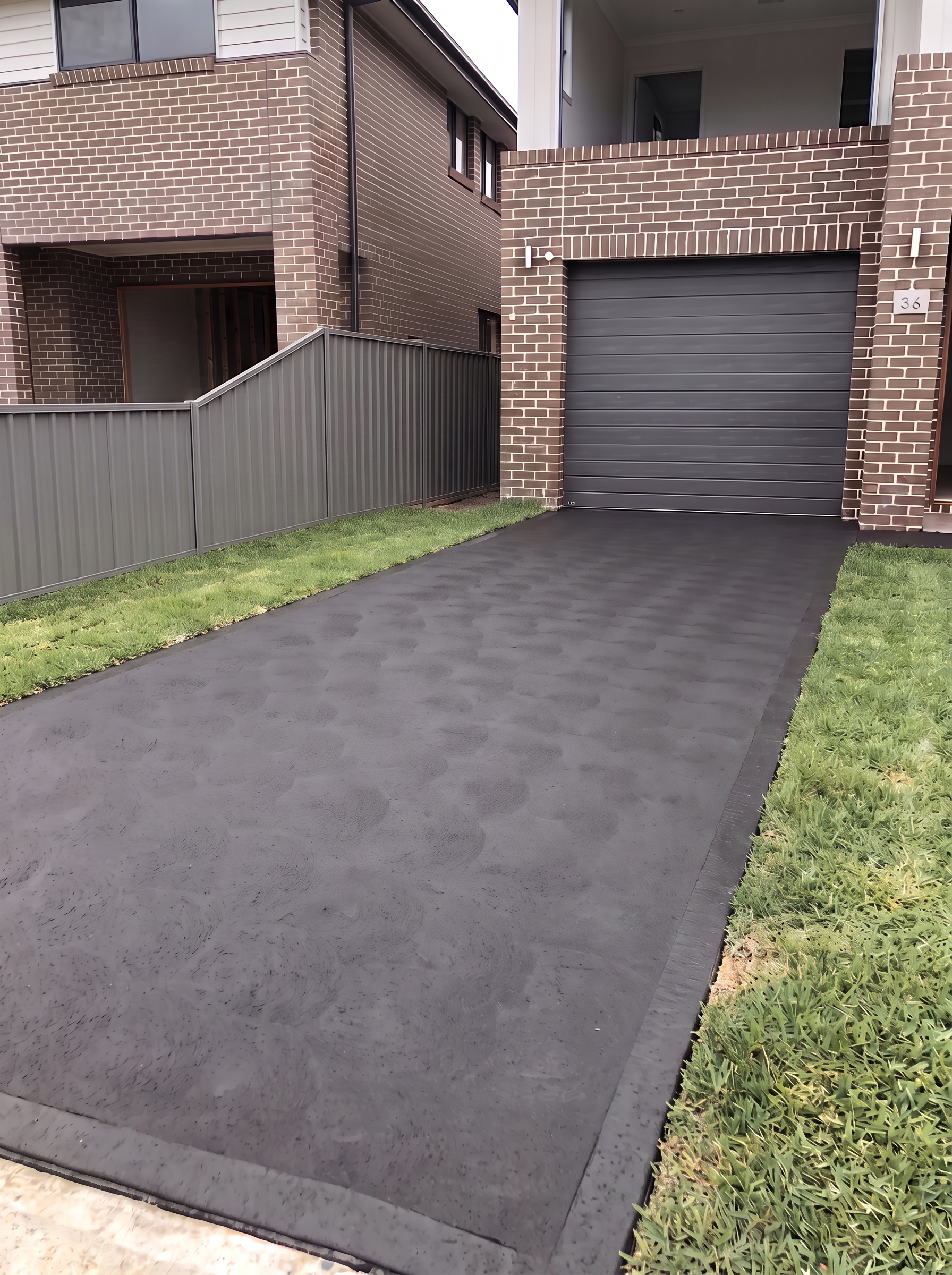 Charcoal grey concrete driveway